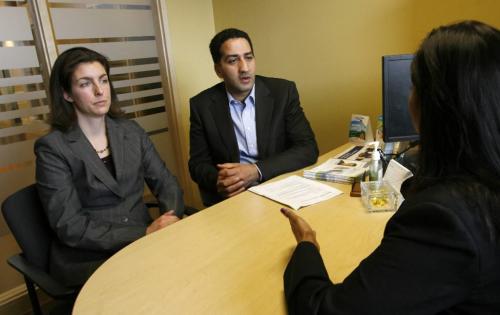 MIKE.DEAL@FREEPRESS.MB.CA 100505 - Wednesday, May 5th, 2010 Charaf Charaoui and his wife Maude Plourde talk to their financial advisor, Zaila Kahn at the Assiniboine Credit Union where the first Islamic Mortgage in Canada. See Geoff Kirbyson story. MIKE DEAL / WINNIPEG FREE PRESS