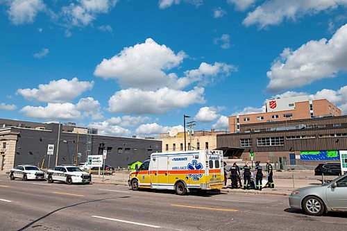 Daniel Crump / Winnipeg Free Press. Winnipeg Police officers and members of the Winnipeg Fire Paramedic Service tend to a handcuffed and hooded person. A heavy police presence could be seen in the area around Logan Avenue And Martha Street around noon on Friday. September 3, 2021.