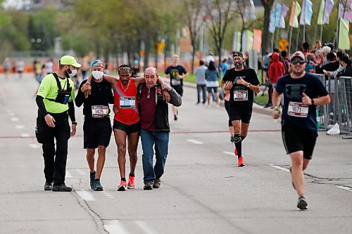 JOHN WOODS / WINNIPEG FREE PRESS
A man is helped across the finish line at the Manitoba Marathon at the University of Manitoba in Winnipeg Sunday, September 5, 2021. 
Reporter: ?