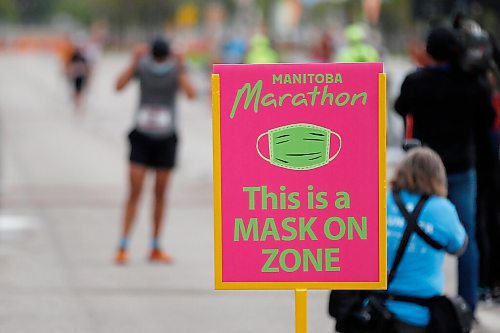 JOHN WOODS / WINNIPEG FREE PRESS
A runner puts on a mask as they cross the half marathon finish line at the Manitoba Marathon at the University of Manitoba in Winnipeg Sunday, September 5, 2021. 

Reporter: ?
