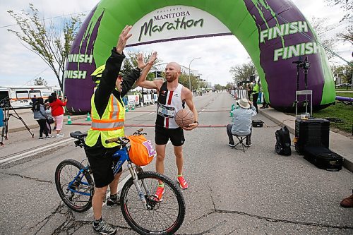 JOHN WOODS / WINNIPEG FREE PRESS
Steffan Reimer gets a high five after crossing the finish line at the Manitoba Marathon at the University of Manitoba in Winnipeg Sunday, September 5, 2021. Steffan Reimer dribbled a ball for the full marathon.
Reporter: ?