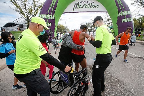 JOHN WOODS / WINNIPEG FREE PRESS
A man is helped across the finish line at the Manitoba Marathon at the University of Manitoba in Winnipeg Sunday, September 5, 2021. 
Reporter: ?