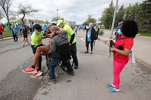 JOHN WOODS / WINNIPEG FREE PRESS
A man is helped across the finish line at the Manitoba Marathon at the University of Manitoba in Winnipeg Sunday, September 5, 2021. 
Reporter: ?