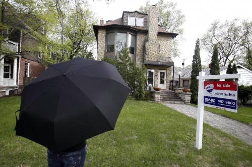BORIS.MINKEVICH@FREEPRESS.MB.CA  100506 BORIS MINKEVICH / WINNIPEG FREE PRESS Money Makeover - xxxx in front of home that xxxxx would like to one day be able to buy. xxxxx wants to crawl out of debt. Here xxxxx poses hiding her identity with an umbrella that she brought along.