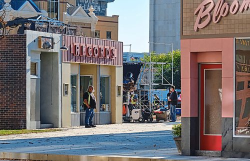 MIKE DEAL / WINNIPEG FREE PRESS
Crews hustle about on the set of the movie, Dark Harvest, which has sprung up in the empty lot where the Market Lands housing development will be across from City Hall on Princess Street. 
210907 - Tuesday, September 07, 2021.