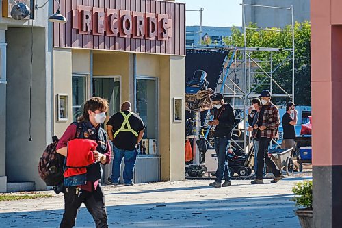 MIKE DEAL / WINNIPEG FREE PRESS
Crews hustle about on the set of the movie, Dark Harvest, which has sprung up in the empty lot where the Market Lands housing development will be across from City Hall on Princess Street. 
210907 - Tuesday, September 07, 2021.