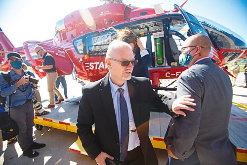 MIKE DEAL / WINNIPEG FREE PRESS
Premier Kelvin Goertzen checks out the new STARS Airbus H145 helicopter at its base at the Winnipeg Airport Monday morning. 
STARS air ambulance introduced its first new Airbus H145 helicopter to Manitoba at its hangar in Winnipeg today.
The new Shock Trauma Air Rescue Service air ambulance is one of 10 that will replace the western Canada fleet.
210907 - Tuesday, September 07, 2021.