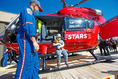 MIKE DEAL / WINNIPEG FREE PRESS
Kaleb Levi Labelle, 6, a VIP who was transported after an accident by STARS in 2016, checks out the new helicopter.
STARS air ambulance introduced its first new Airbus H145 helicopter to Manitoba at its hangar in Winnipeg today.
The new Shock Trauma Air Rescue Service air ambulance is one of 10 that will replace the western Canada fleet.
210907 - Tuesday, September 07, 2021.