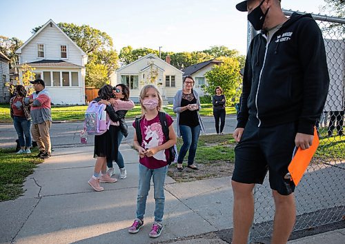 JESSICA LEE/WINNIPEG FREE PRESS

Olivia Walker, who is going into grade 2, walks into Glenelm Community School past teacher David Sharp for the first day of school on September 8, 2021.

Reporter: Maggie