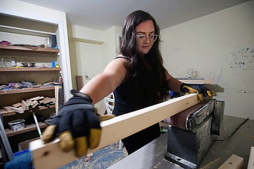 JOHN WOODS / WINNIPEG FREE PRESS
Kaelyn Proutt planes wood at her basement workshop in Selkirk Wednesday, September 8, 2021. Matt and Kaelyn Proutt have started M+K Wood Co., a business that started as a cabinet supplier but now turns out custom, wooden kennels for dogs.

Reporter: ?