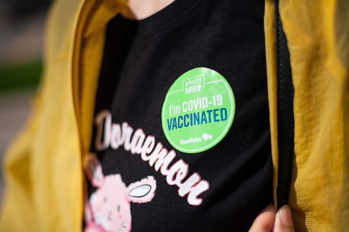 Daniel Crump / Winnipeg Free Press. Sun Xu shows off her sticker after being vaccinated at the Assiniboine Park pop up vaccination centre Saturday morning. September 11, 2021.