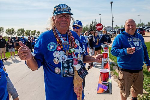 Daniel Crump / Winnipeg Free Press. John Cooch Couture holds his Shotski from which he offers people drinks during the tailgate celebrations prior to the Banjo Bowl at IG Field Saturday afternoon. September 11, 2021.