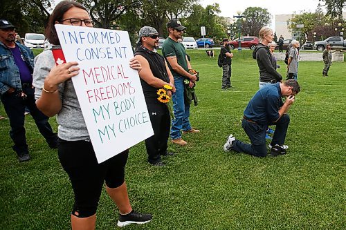 JOHN WOODS / WINNIPEG FREE PRESS
A man kneels as about 150 anti-maskers/vaxxers gathered at the MB Legislature and walked to the City Hall in protest against COVID-19 vaccinations and masks in Winnipeg Monday, September 13, 2021. 

Reporter: Silva