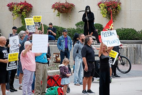 JOHN WOODS / WINNIPEG FREE PRESS
A person dressed as the Grime Reaper looks on as about 150 anti-maskers/vaxxers gathered at the MB Legislature and walked to the City Hall in protest against COVID-19 vaccinations and masks in Winnipeg Monday, September 13, 2021. 

Reporter: Silva