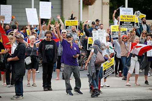 JOHN WOODS / WINNIPEG FREE PRESS
Protestors waves to passing vehicles at city hall. About 150 anti-maskers/vaxxers gathered at the MB Legislature and walked to the City Hall in protest against COVID-19 vaccinations and masks in Winnipeg Monday, September 13, 2021. 

Reporter: Silva