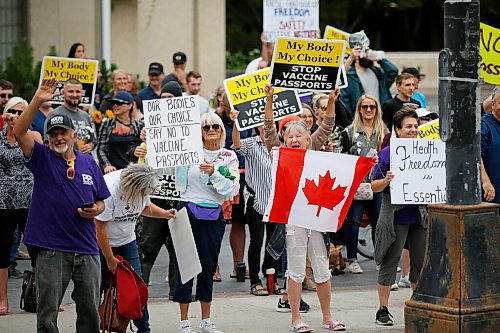 JOHN WOODS / WINNIPEG FREE PRESS
Protestors waves to passing vehicles at city hall. About 150 anti-maskers/vaxxers gathered at the MB Legislature and walked to the City Hall in protest against COVID-19 vaccinations and masks in Winnipeg Monday, September 13, 2021. 

Reporter: Silva