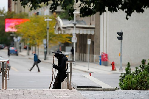 JOHN WOODS / WINNIPEG FREE PRESS
The person dressed as the Grim Reaper takes a break after a rally where about 150 anti-maskers/vaxxers gathered at the MB Legislature and walked to the City Hall in protest against COVID-19 vaccinations and masks in Winnipeg Monday, September 13, 2021. 

Reporter: Silva