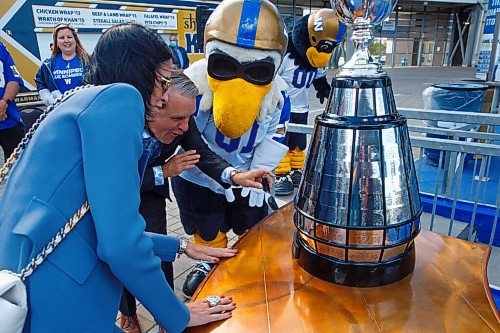MIKE DEAL / WINNIPEG FREE PRESS
Dayna Spiring, chair, board of directors, Winnipeg Football Club and Cameron Friesen, Minister of Justice and Attorney General, find the 2019 championship plaque with Dayna's name on it on the Grey Cup before a ceremony at IG Field Tuesday afternoon.
Premier Kelvin Goertzen, Wade Miller, president and CEO, Winnipeg Football Club and Dayna Spiring, chair, board of directors, Winnipeg Football Club along with other dignitaries were on hand at IG Field Tuesday afternoon, for the signing-in of the 2019 Grey Cup Champions into the Order of the Buffalo Hunt.
210914 - Tuesday, September 14, 2021.