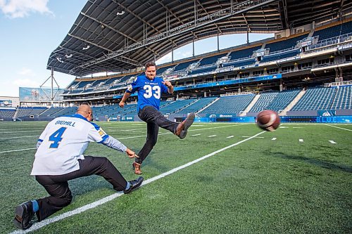 MIKE DEAL / WINNIPEG FREE PRESS
MLAs James Teitsma kicks a football being held by Jon Reyes on the IG Field.
Premier Kelvin Goertzen, Wade Miller, president and CEO, Winnipeg Football Club and Dayna Spiring, chair, board of directors, Winnipeg Football Club along with other dignitaries were on hand at IG Field Tuesday afternoon, for the signing-in of the 2019 Grey Cup Champions into the Order of the Buffalo Hunt.
210914 - Tuesday, September 14, 2021.