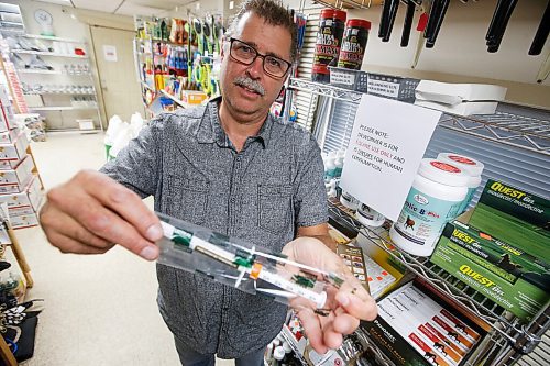 JOHN WOODS / WINNIPEG FREE PRESS
Glenn Miller, owner of Anola Feed & Farm Supply in Anola, is photographed showing the dosage guide for horses on an Ivermectin syringe in his store Thursday, September 16, 2021. Miller has posted signs in his store saying that the horse deworming medication is intended for veterinary use only. The not for human use signage is required because of the increase in enquiries for the drug to help with prevention of COVID-19.

Reporter: May