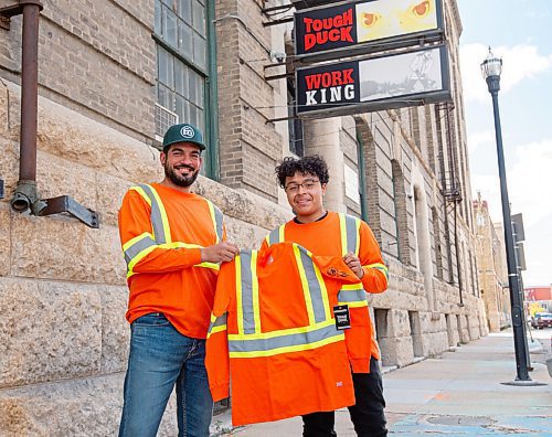 MIKE SUDOMA / Winnipeg Free Press
Young artist, Isaiah Binns (right), and his former graphic design teacher, Mathew Reis, hold up a piece of work wear with a design on the sleeve done by Binns
 September 17, 2021