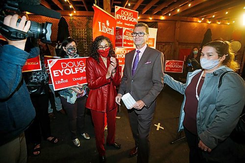 JOHN WOODS / WINNIPEG FREE PRESS Doug Eyolfson, Liberal candidate in Charleswood-St James-Assiniboia-Headingley, walks through supporters after speaking during a party at the Cork and Flame on Portage Avenue, in Winnipeg Monday, September 20, 2021. 

Reporter: Katie