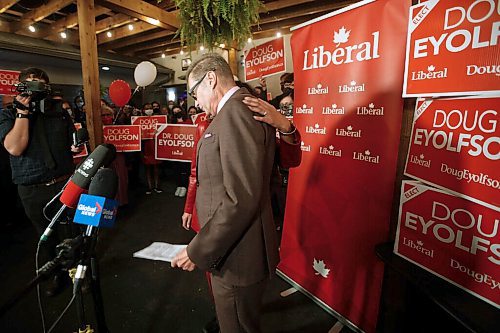 JOHN WOODS / WINNIPEG FREE PRESS Doug Eyolfson, Liberal candidate in Charleswood-St James-Assiniboia-Headingley, is embraced by his wife Sowmya as he speaks to media and supporters during a party at the Cork and Flame on Portage Avenue, in Winnipeg Monday, September 20, 2021. 

Reporter: Katie