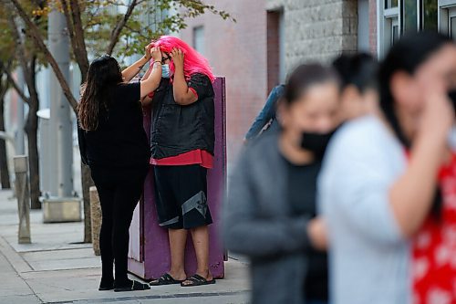 JOHN WOODS / WINNIPEG FREE PRESS
A fans gets a wig adjustment before entering the Electric Circus concert at a downtown arena in Winnipeg Tuesday, September 21, 2021. 

Reporter: ?