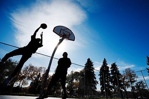 JOHN WOODS / WINNIPEG FREE PRESS
Desmond, right, and Hafiz shoot hoops on a beautiful day at St Johns Park in Winnipeg Sunday, September 26, 2021. 

Reporter: Standup