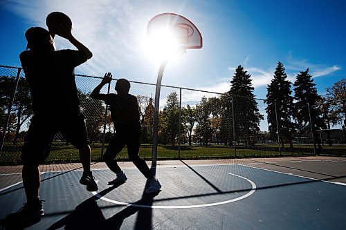 JOHN WOODS / WINNIPEG FREE PRESS
Desmond, left, and Hafiz shoot hoops on a beautiful day at St Johns Park in Winnipeg Sunday, September 26, 2021. 

Reporter: Standup