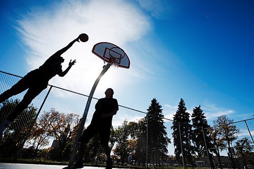 JOHN WOODS / WINNIPEG FREE PRESS
Desmond, right, and Hafiv shoot hoops on a beautiful day at St Johns Park in Winnipeg Sunday, September 26, 2021. 

Reporter: Standup