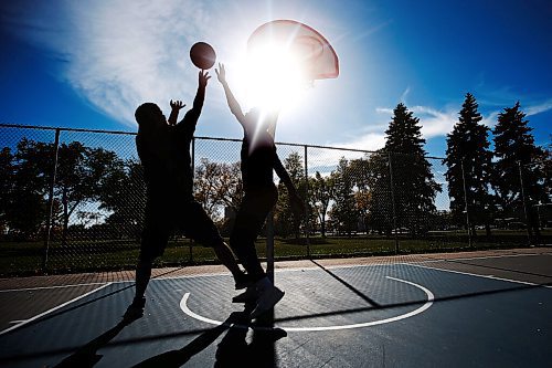 JOHN WOODS / WINNIPEG FREE PRESS
Desmond, left, and Hafiz shoot hoops on a beautiful day at St Johns Park in Winnipeg Sunday, September 26, 2021. 

Reporter: Standup