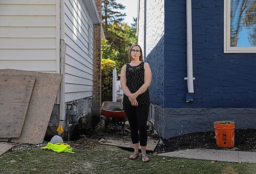 JESSICA LEE / WINNIPEG FREE PRESS

Kaitlin Bialek stands in the space between her house and her neighbours on September 27, 2021. In late May, due to a city contractor error, cement flooded the pipes of her home and several surrounding homes on Semple Avenue. She recently had all of the affected pipes removed and replaced, which her neighbour is now in the process of doing. Workers behind her are filling up the holes after her neighbours pipe replacement.

Reporter: Joyanne