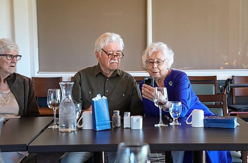 JESSICA LEE / WINNIPEG FREE PRESS

Vanita Schmidt, holds her phone as Jake and Irene, another couple part of Club 56 video calls from Edmonton on September 22, 2021 during the last Club 56 meet-up.

In 1956, 14 couples from Winnipeg married and formed a club they called Club 56. They have been meeting every year since 1956, however this meeting is their last meeting because the members are aging and some have moved out of the province. The original group of 28 is now a group of 14 as some members have passed away or moved out of province.

Reporter: Ben