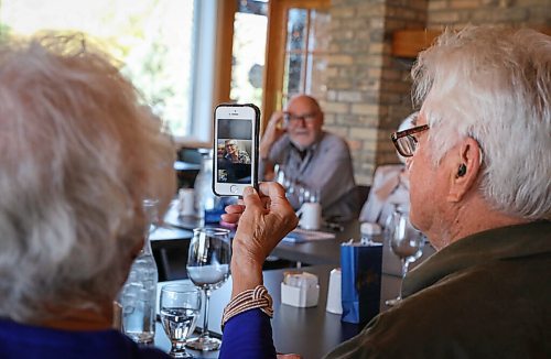 JESSICA LEE / WINNIPEG FREE PRESS

Vanita Schmidt, holds her phone as Jake and Irene, another couple part of Club 56 video calls from Edmonton on September 22, 2021 during the last Club 56 meet-up.

In 1956, 14 couples from Winnipeg married and formed a club they called Club 56. They have been meeting every year since 1956, however this meeting is their last meeting because the members are aging and some have moved out of the province. The original group of 28 is now a group of 14 as some members have passed away or moved out of province.

Reporter: Ben