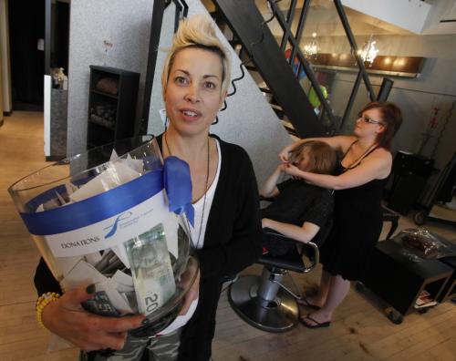 BORIS.MINKEVICH@FREEPRESS.MB.CA  100516 BORIS MINKEVICH / WINNIPEG FREE PRESS Candess Remo holds over $2400 in donations she shop Society the Salon where a 24 hour haircut-a-thon happened(120 Donald). The owner along with 14 other stylist  over 150 cuts during the event. Her dad Bill Goodine, owner of Goodine's Hairstyling for Men for 47 years, died of prostate cancer. They raised funds and awareness for prostate cancer research.