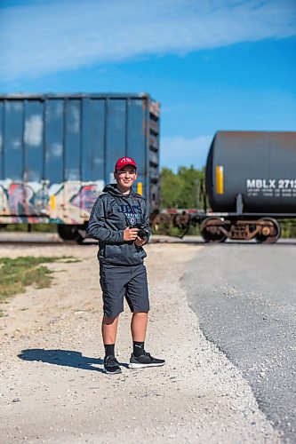 MIKAELA MACKENZIE / WINNIPEG FREE PRESS

Trainspotter Evan McRae, 13, poses for a portrait east of Symington Yards in Winnipeg on Monday, Sept. 27, 2021.  For the last two years, the young rail fan has been going out to watch trains around the city. For --- story.
Winnipeg Free Press 2021.