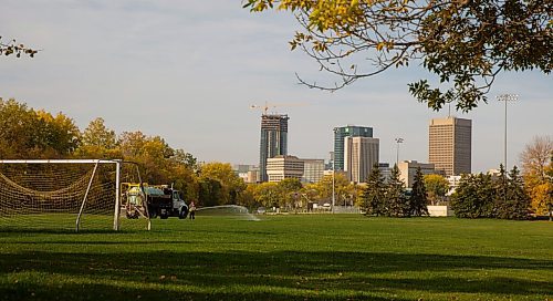 MIKE DEAL / WINNIPEG FREE PRESS
City of Winnipeg Parks employee, Leann Carriere, waters fresh sod at the soccer pitch in Whittier Park early Wednesday morning.
210929 - Wednesday, September 29, 2021.