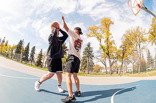 MIKE SUDOMA / Winnipeg Free Press
(Left to right) Brad and Josh play a little one on one as they enjoy the summer like weather Wednesday afternoon at the basketball courts in St Johns Park.
September 29, 2021