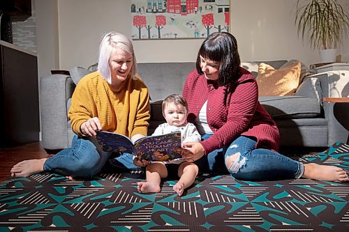 MIKE SUDOMA / Winnipeg Free Press
Brenlee Coates (left), her partner Amanda Karpinsky (right) and their daughter Lark read Coates self published childrens book, You Came From My Heart Wednesday afternoon
September 29, 2021