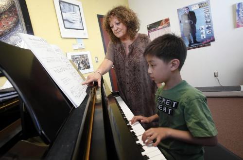 BORIS.MINKEVICH@FREEPRESS.MB.CA  100516 BORIS MINKEVICH / WINNIPEG FREE PRESS William Ho gets a piano lesson from faculty member Maura Doyle Hosie. Manitoba Conservatory of Music and Arts.