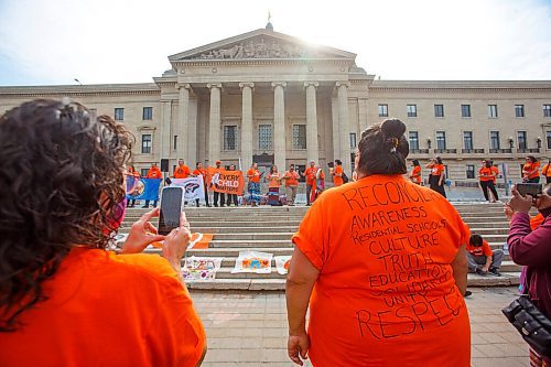 MIKE DEAL / WINNIPEG FREE PRESS
Haven Stumpf a daughter of a residential school survivor wears an orange t-shirt with the words, "Reconciliation, Awareness, Residential Schools, Culture, Truth, Education, Solidarity, Unity, Respect," written on the back, watches as singers perform on the steps of the legislative building.
Members of the Fox Lake Cree Nation, York Factory First Nation and Tataskweyak Cree Nation  including leadership, residential school survivors and youth gather of the steps of the Manitoba Legislative building after walking from Winnipeg's Victoria Inn at 1808 Wellington Ave. during the National Day for Truth and Reconciliation, on Thursday.
210930 - Thursday, September 30, 2021.