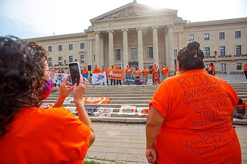 MIKE DEAL / WINNIPEG FREE PRESS
Haven Stumpf a daughter of a residential school survivor wears an orange t-shirt with the words, "Reconciliation, Awareness, Residential Schools, Culture, Truth, Education, Solidarity, Unity, Respect," written on the back, watches as singers perform on the steps of the legislative building.
Members of the Fox Lake Cree Nation, York Factory First Nation and Tataskweyak Cree Nation  including leadership, residential school survivors and youth gather of the steps of the Manitoba Legislative building after walking from Winnipeg's Victoria Inn at 1808 Wellington Ave. during the National Day for Truth and Reconciliation, on Thursday.
210930 - Thursday, September 30, 2021.