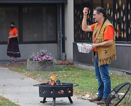 JESSICA LEE / WINNIPEG FREE PRESS

Fire keeper Richard Shrupka throws tobacco into a sacred fire at Ma Mawi Wi Chi Itata Centre on September 30, 2021 for Truth and Reconciliation Day. The tobacco was gathered by youth and the bundles represent anguish, pain, hopes and dreams. The bundles are thrown into the fire in hopes that the creator will listen.

