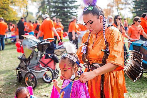 MIKAELA MACKENZIE / WINNIPEG FREE PRESS

Callie Thompson (six) gets her shawl adjusted by her mom, Pamela Demas, at a Pow Wow at St. John's Park on the first National Day for Truth and Reconciliation in Winnipeg on Thursday, Sept. 30, 2021. For --- story.
Winnipeg Free Press 2021.