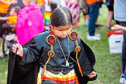 MIKAELA MACKENZIE / WINNIPEG FREE PRESS

Anastasia Hudson (five) plays at a Pow Wow at St. John's Park on the first National Day for Truth and Reconciliation in Winnipeg on Thursday, Sept. 30, 2021. For --- story.
Winnipeg Free Press 2021.