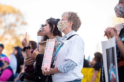 MIKE SUDOMA / Winnipeg Free Press
Womens health advocates/supporters hold signs outside of the Manitoba Legislature as they listen to Uzomo Asagwara speak Saturday
October 2, 2021