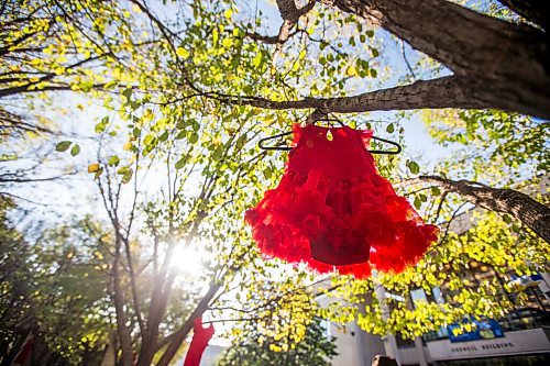 MIKAELA MACKENZIE / WINNIPEG FREE PRESS

A baby dress (acknowledging the lost future lives) hangs in the courtyard at City Hall in honour of a day of action and awareness for missing and murdered Indigenous women, girls, and two-spirited peoples in Winnipeg on Monday, Oct. 4, 2021. For --- story.
Winnipeg Free Press 2021.