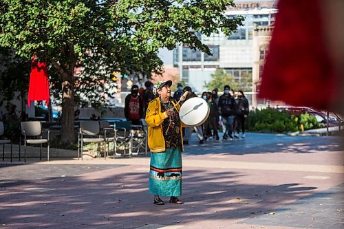 MIKAELA MACKENZIE / WINNIPEG FREE PRESS

Bev Jones sings a bear song at a sacred fire at City Hall in honour of a day of action and awareness for missing and murdered Indigenous women, girls, and two-spirited peoples in Winnipeg on Monday, Oct. 4, 2021. For --- story.
Winnipeg Free Press 2021.