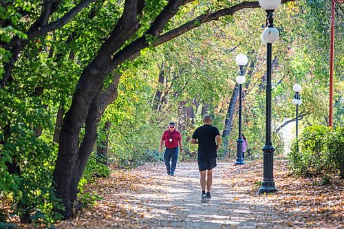 MIKAELA MACKENZIE / WINNIPEG FREE PRESS

Trevor Gamble (left) takes a walk at The Forks in Winnipeg on Monday, Oct. 4, 2021. Winnipeg has been setting weather records with the gloriously warm fall weather. For JS story.
Winnipeg Free Press 2021.